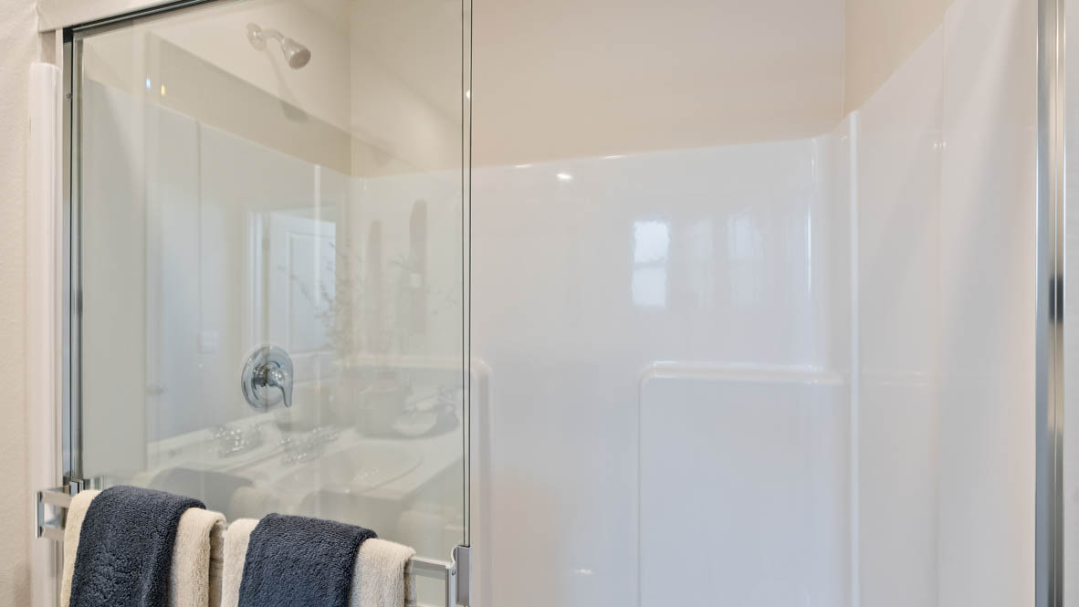 Monrovia Primary bathroom with double vanity, walk in shower, quartz countertops, walk in shower