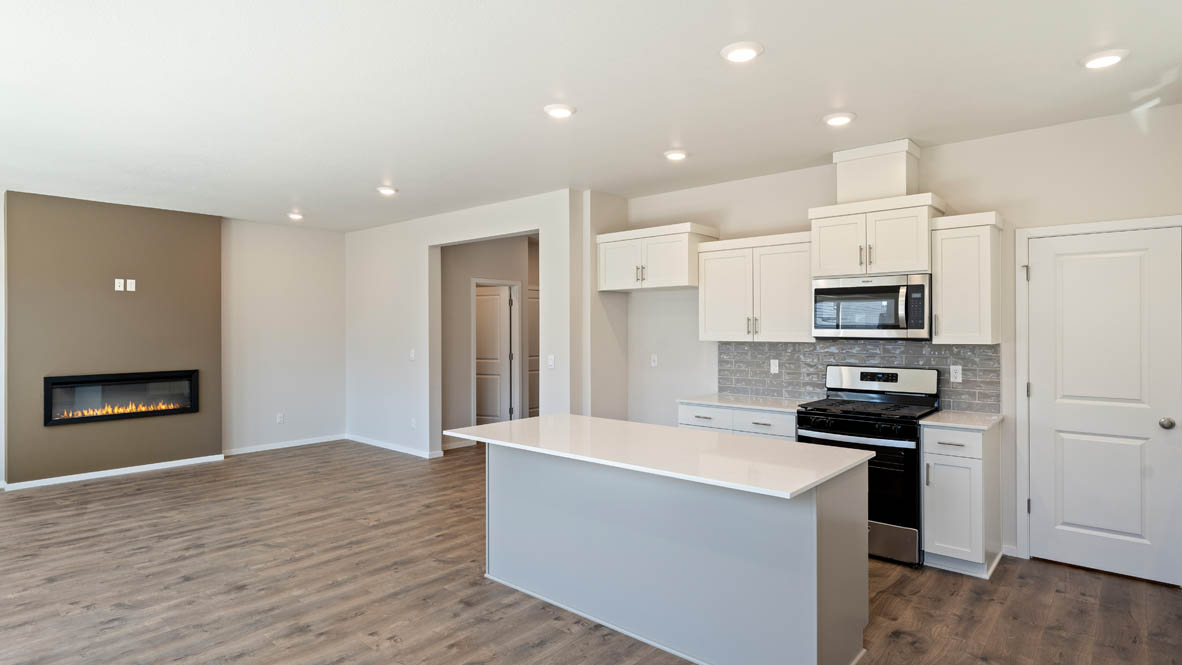 Monrovia kitchen with stainless steel appliances, island, window, and shaker style cabinetry