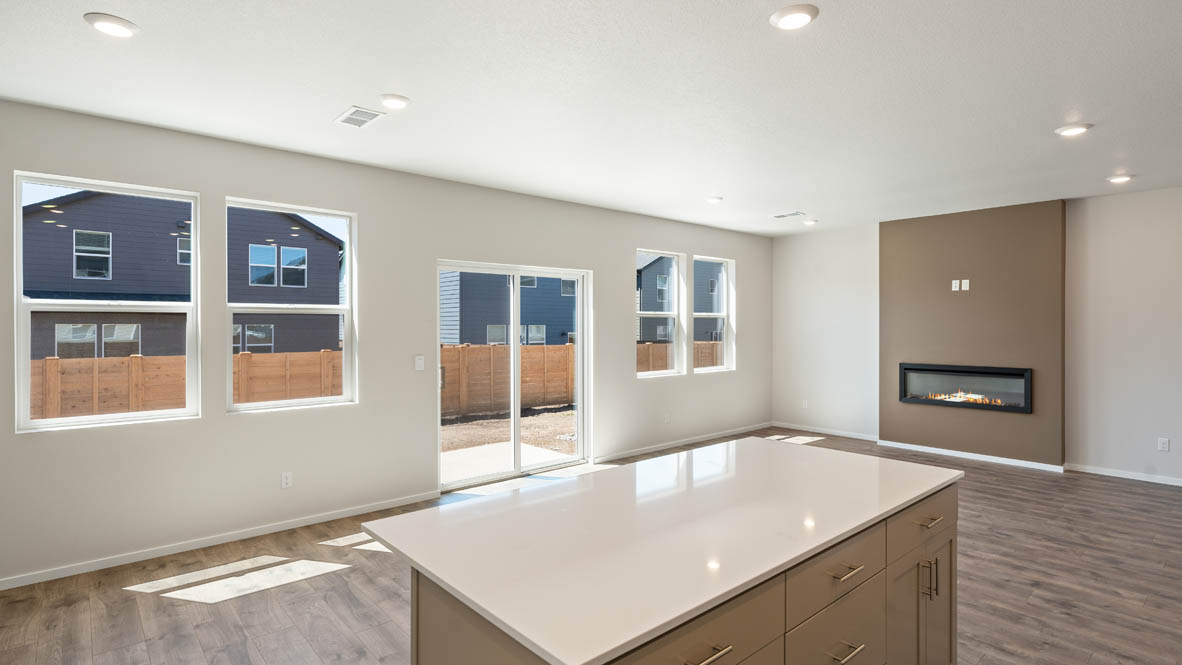 Monrovia kitchen with stainless steel appliances, island, window, and shaker style cabinetry
