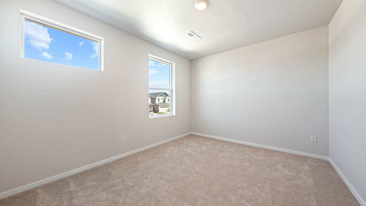 Monrovia bedroom with carpet, white walls, and windows