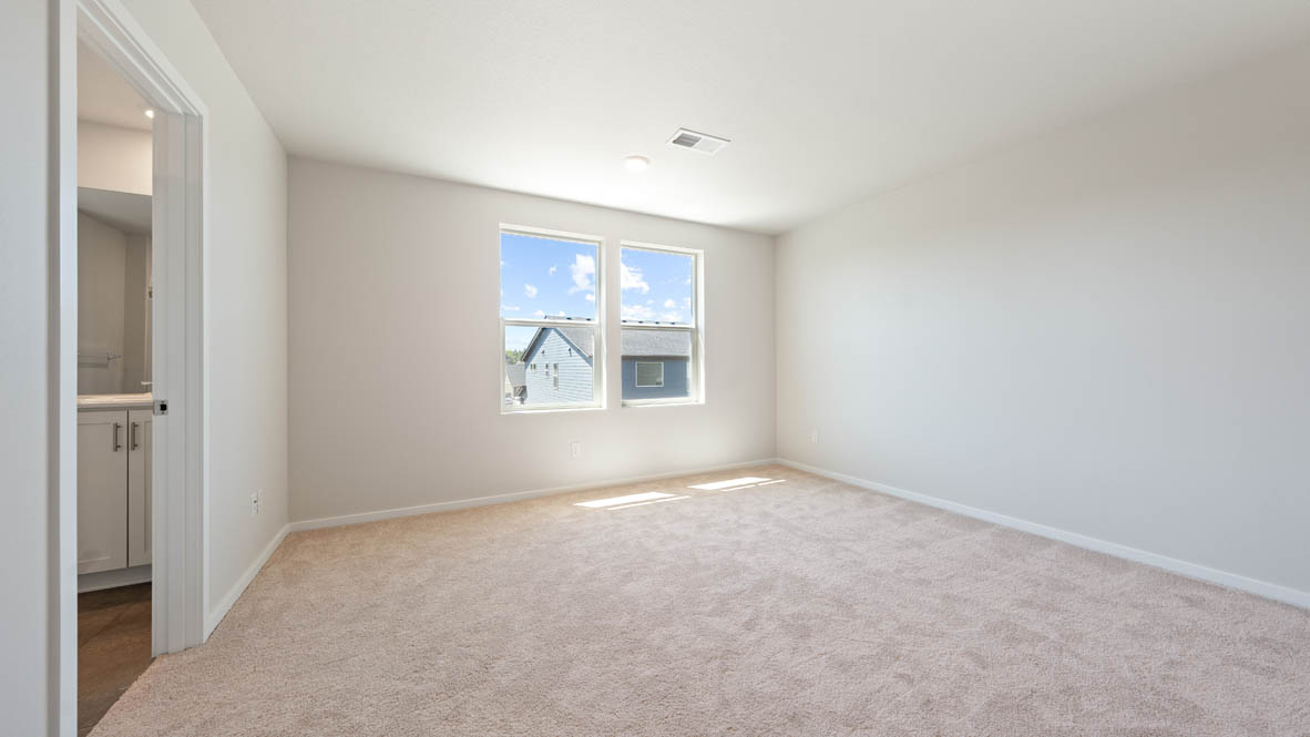 Monrovia primary bedroom with closet, windows, carpet, and white walls