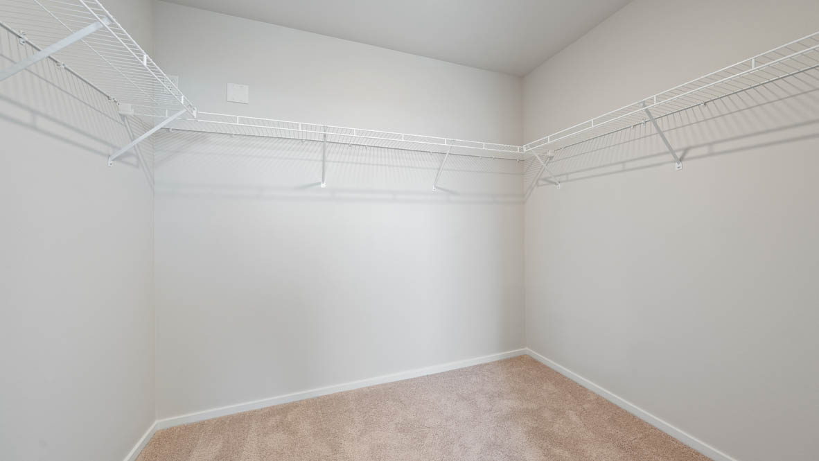 Monrovia walk in closet with white wire shelving