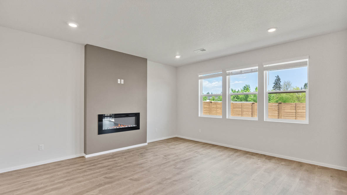 Monrovia Great room with laminate flooring, electric fireplace, and windows