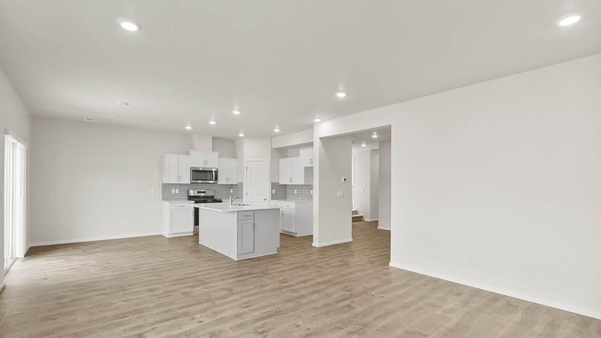 Monrovia kitchen with island, stainless steel appliances, and windows