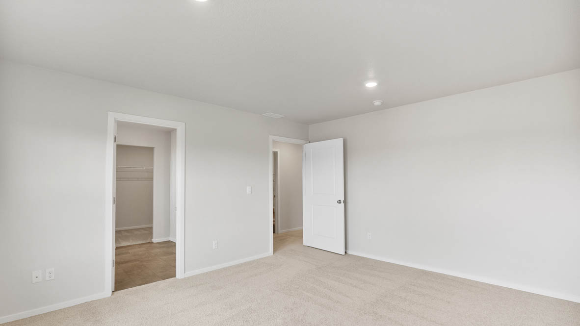 Monrovia Primary bedroom with carpet, closet, and white walls