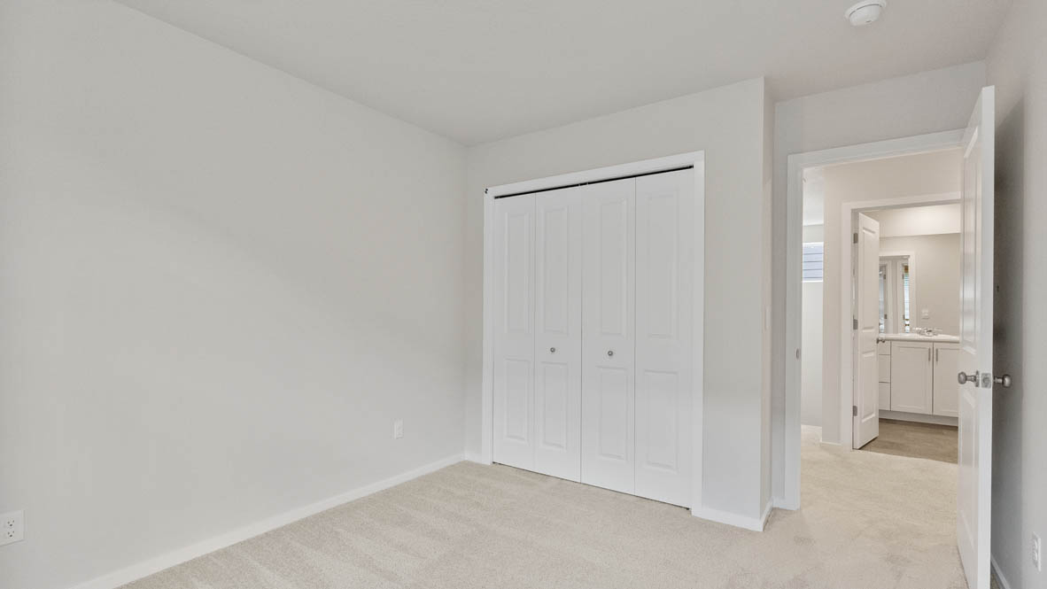 Monrovia bedroom with carpet, closet, and white walls