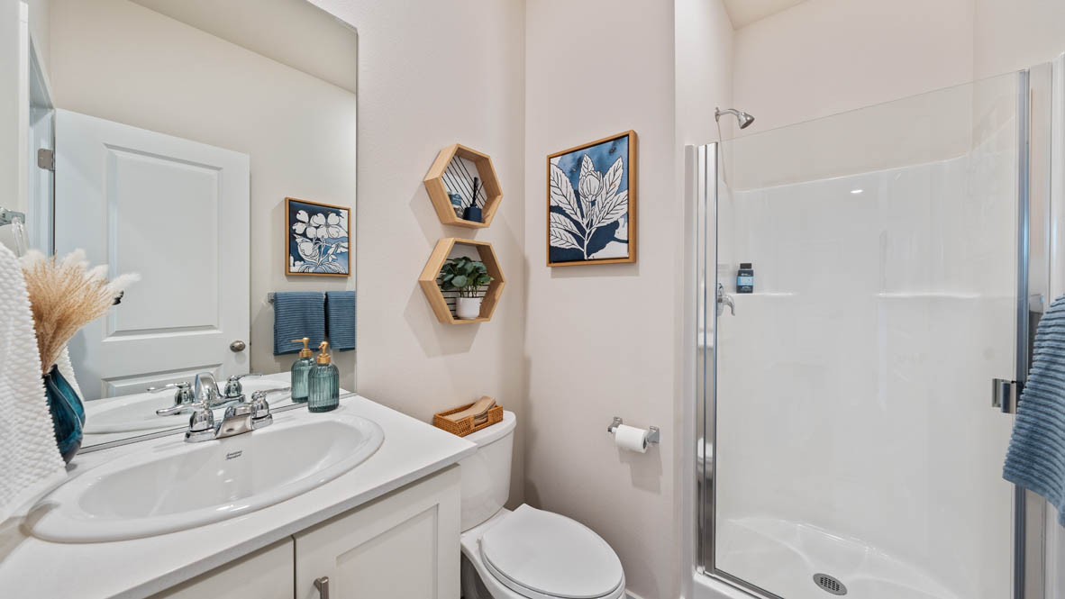 Monrovia powder bathroom with single sink vanity and standing shower