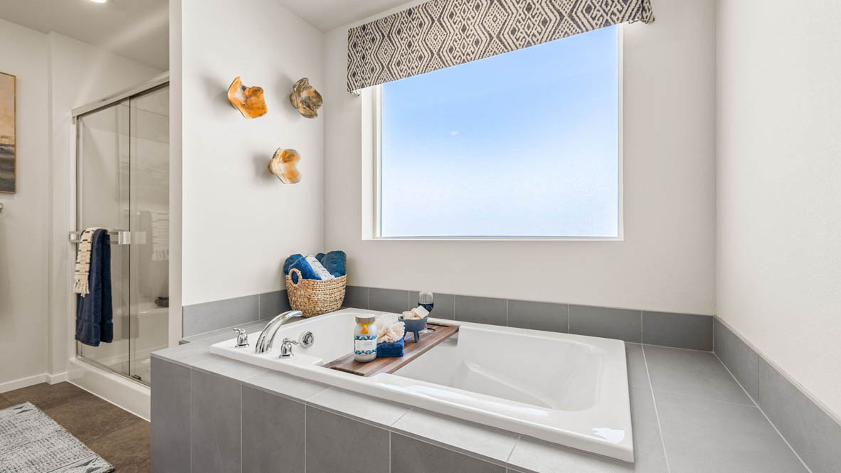 Monrovia Primary bathroom with walk in shower with glass doors and tub