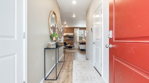 Lowrie Estates Entry with red door and mirror with entry table
