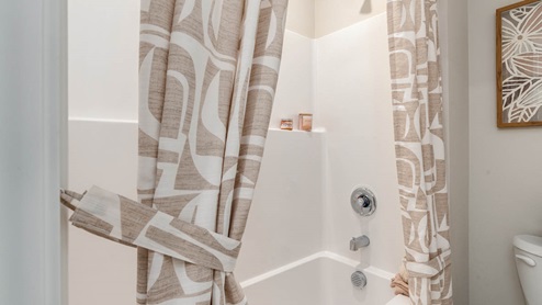 Lowrie Estates secondary bathroom with a tub shower and curtains