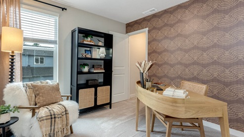 Scholls Meadow staged bedroom with makeshift office space with desk, chair, black shelving