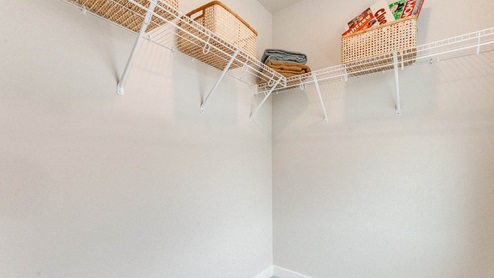 Scholls Meadow walk in closet with white wire shelving