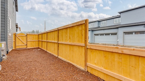 Scholls Meadow side yard with bark dust and fencing