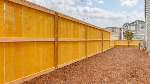 Scholls Meadow side yard with bark dust and fencing
