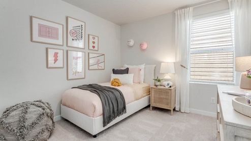 Davis Estates bedroom with side table and a lamp, bed, paintings, desk, and window with shades