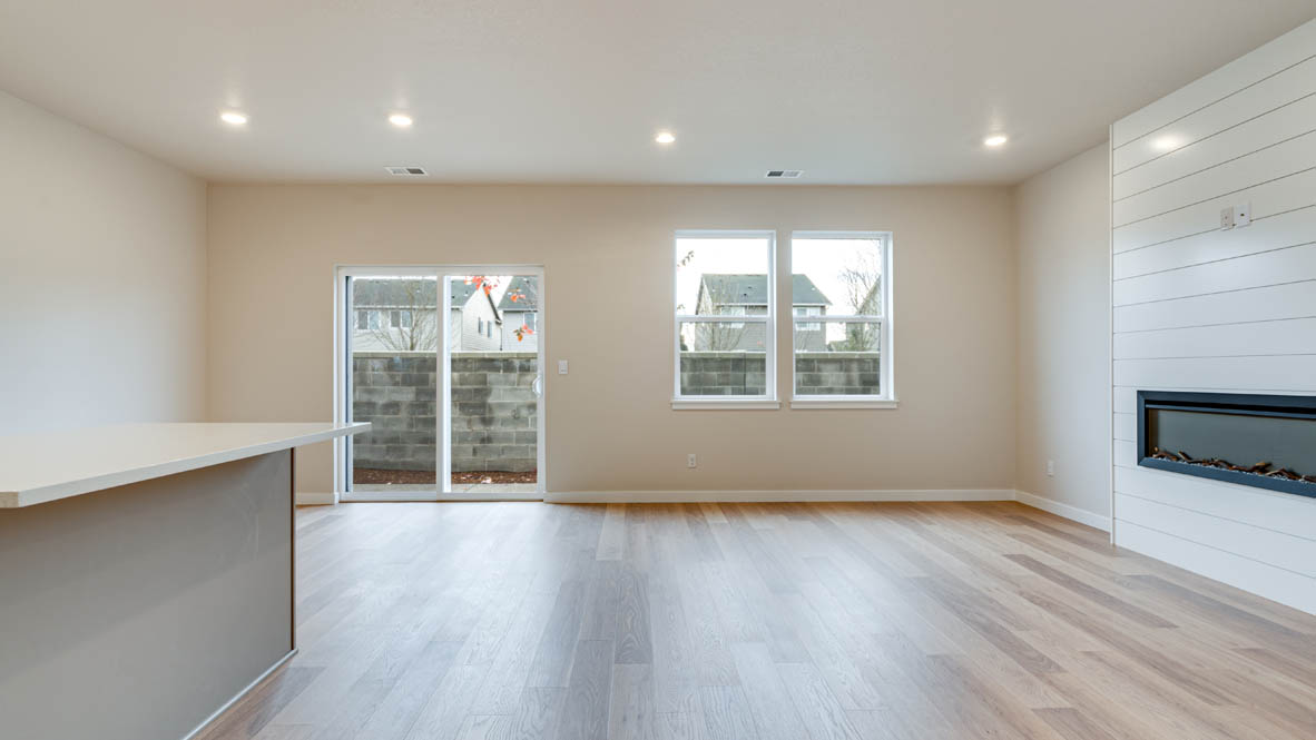 Davis Estates great room with fireplace and laminate flooring