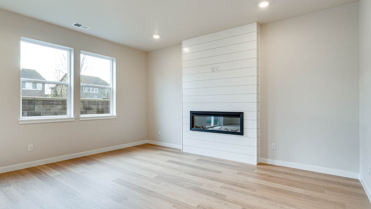 Davis Estates great room with white walls and electric fireplace