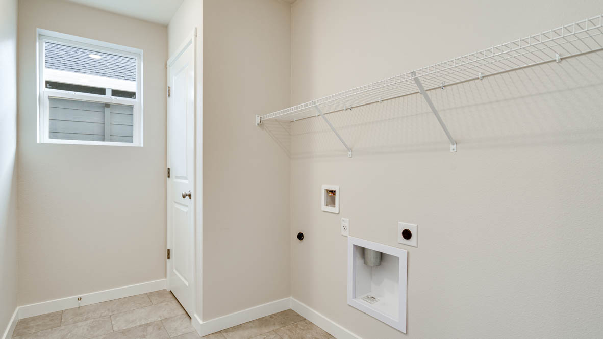 Davis Estates laundry room with white wire shelving