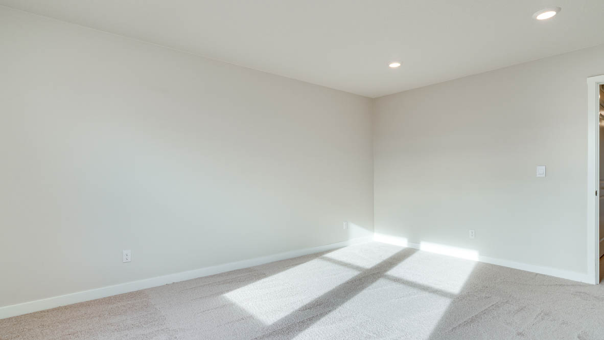 Davis Estates primary bedroom with carpeting and white walls and windows