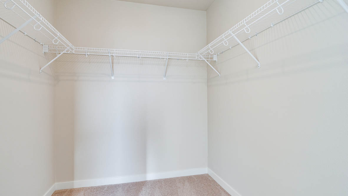 Davis Estates walk in closet with white wire shelving