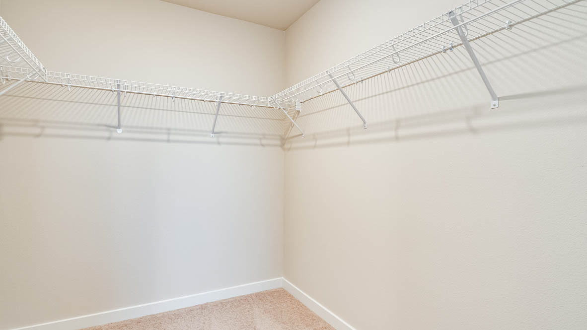 Davis Estates walk in closet with white wire shelving