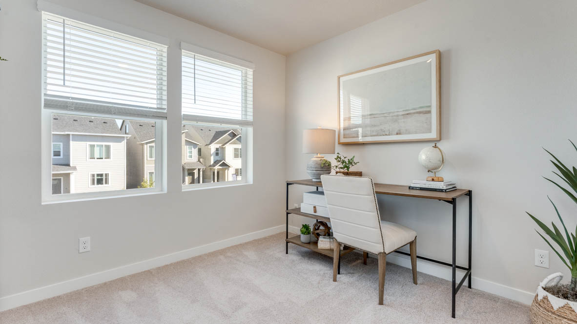 Davis Estates Bedroom with desk and chair looking over a painting, a plant, carpet, and windows