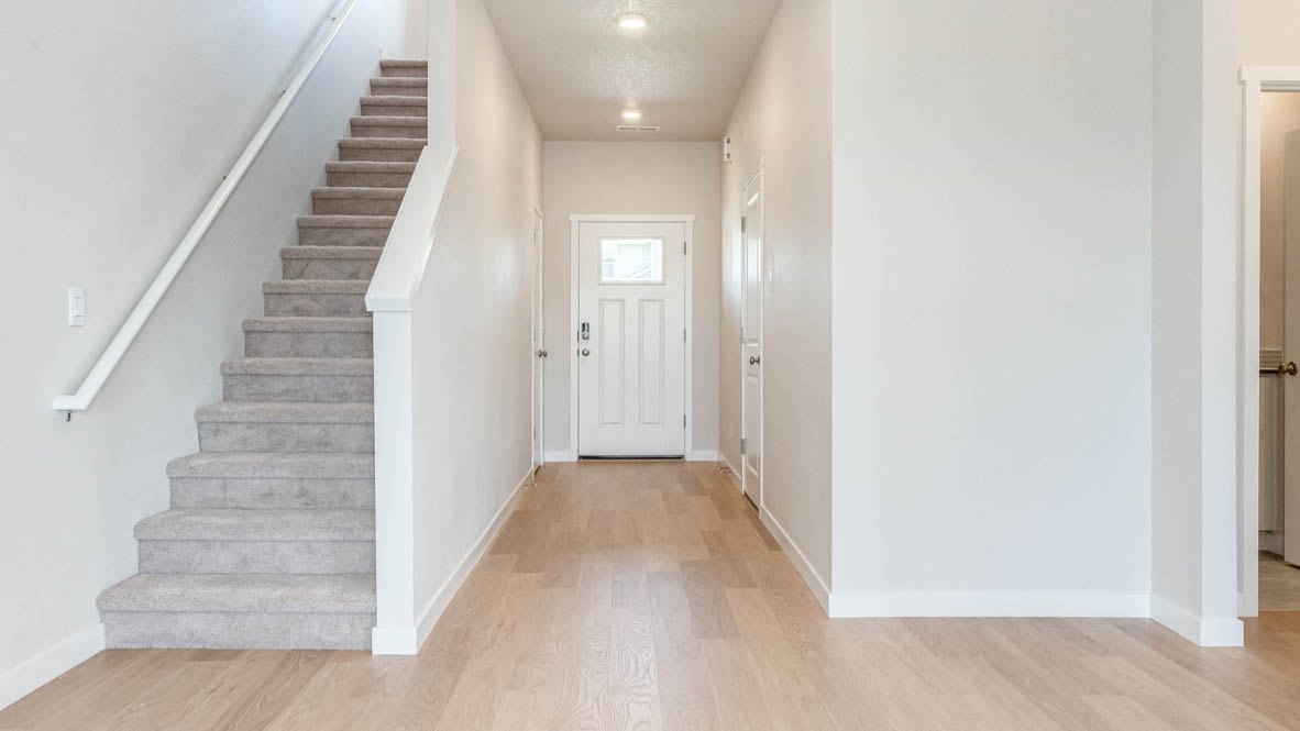 Davis Estates Entry with carpeted stairs, laminate flooring, and white walls