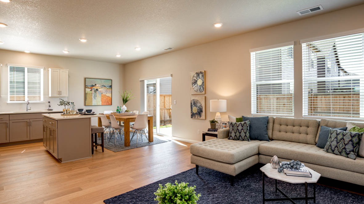 Davis Estates great room with fireplace, laminate flooring, and windows
