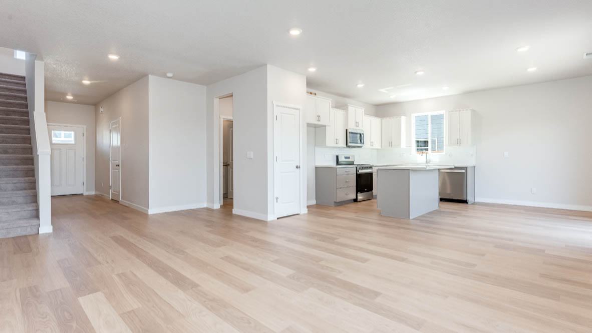 Davis Estates kitchen with laminate flooring, stainless steel appliances, cabinets, window, solid surface countertops