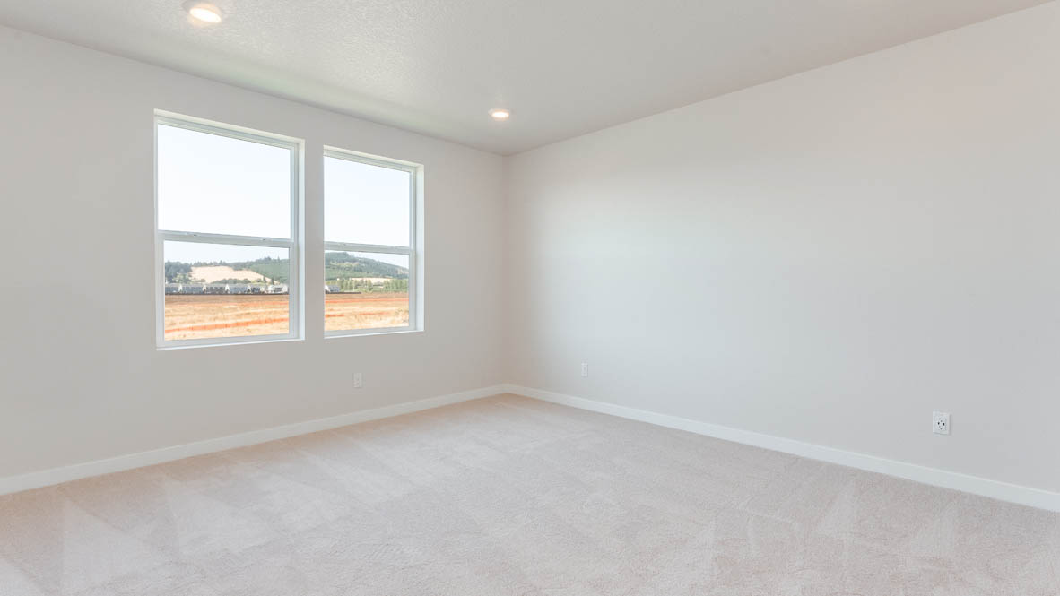Davis Estates primary bedroom with carpet, window, and white walls