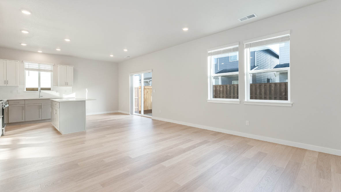 Davis Estates great room with fireplace, laminate flooring, and windows