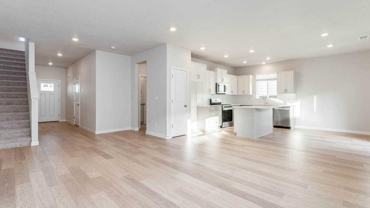 Davis Estates kitchen with laminate flooring, stainless steel appliances, cabinets, window, solid surface countertops