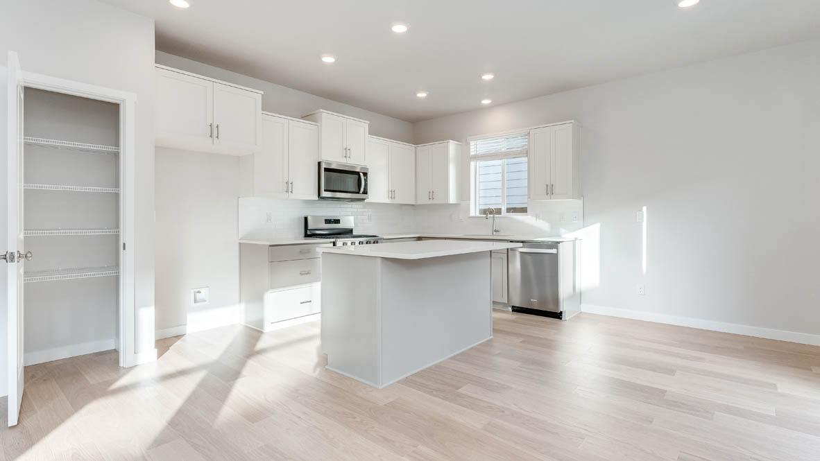 Davis Estates kitchen with laminate flooring, stainless steel appliances, cabinets, window, solid surface countertops