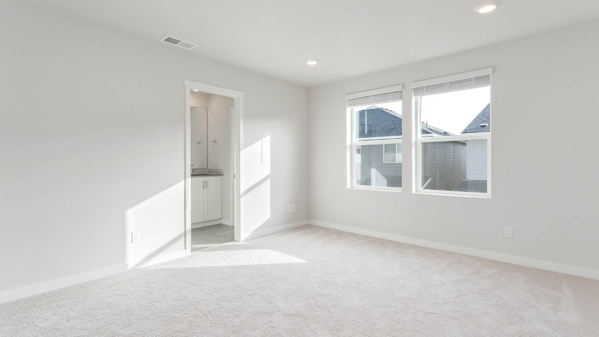 Davis Estates primary bedroom with carpet, window, and white walls