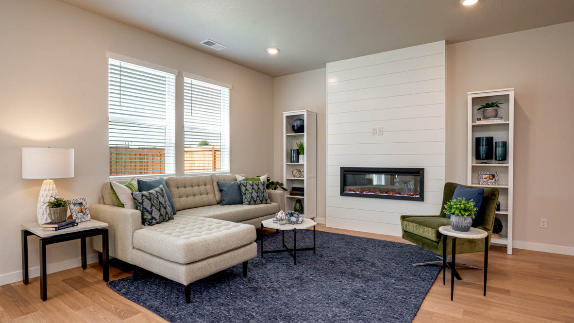 Davis Estates great room with fireplace, laminate flooring, and windows