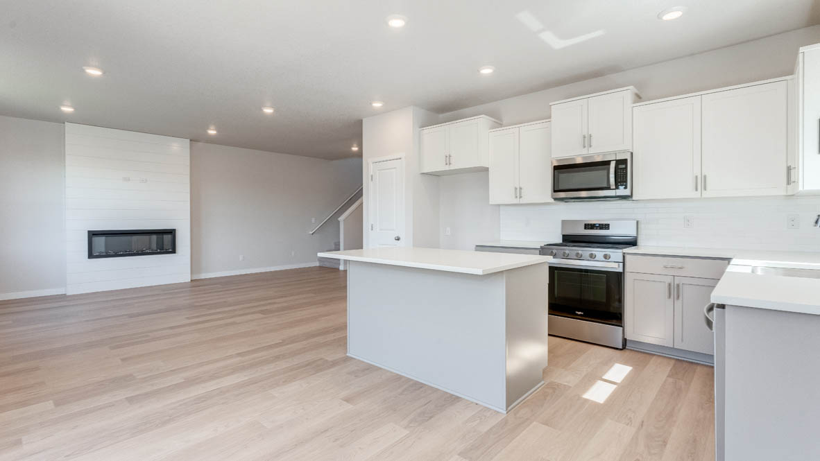 Davis Estates kitchen with laminate flooring, stainless steel appliances, cabinets, window, solid surface countertops