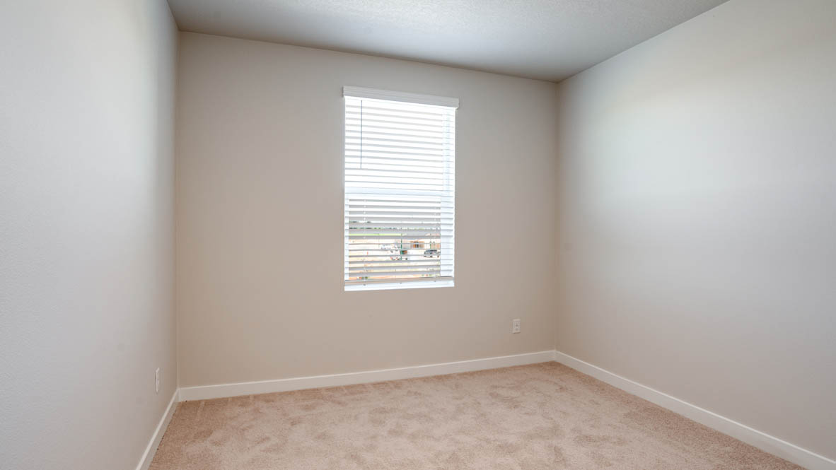 Davis Estates bedroom with carpet, window, and white walls