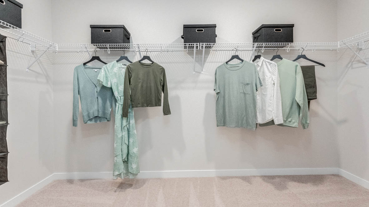 Davis Estates walk-in closet with white wire hangers