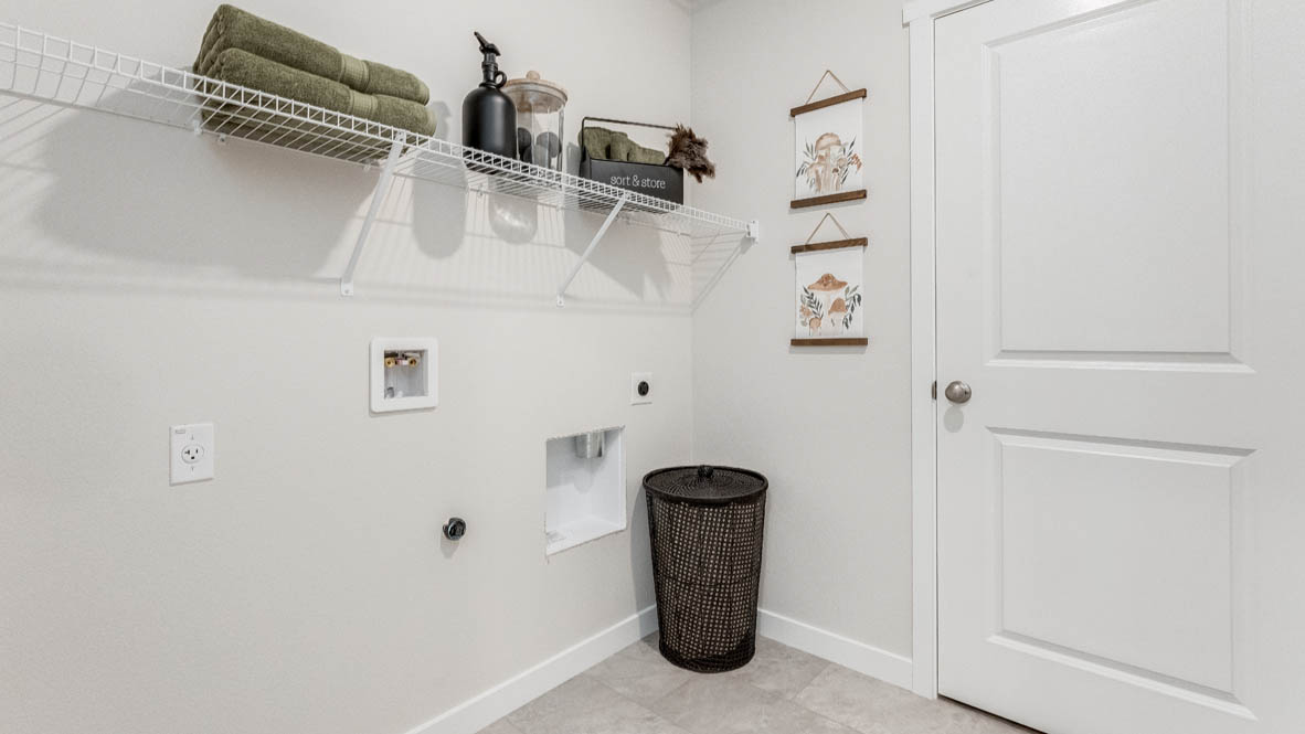 Davis Estates laundry room with white wire shelving, and a hamper