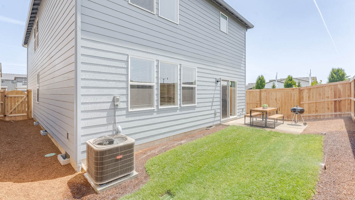 Davis Davis Estates backyard with a table, bark dust, a fence, and grassbackyard with grass and a table