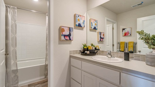 Marcola Meadows Bathroom with tub shower and curtains and a toilet and a single sink vanity