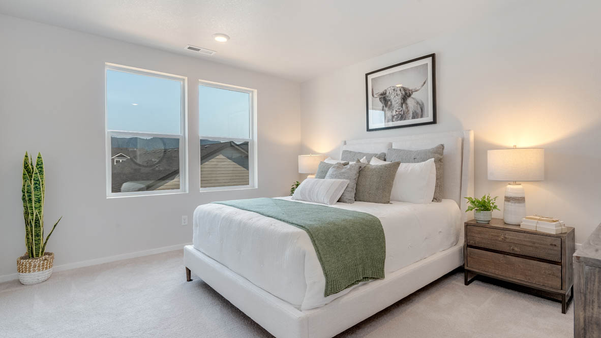 Marcola Meadows Primary bedroom with bed, windows, nightstand with lamp