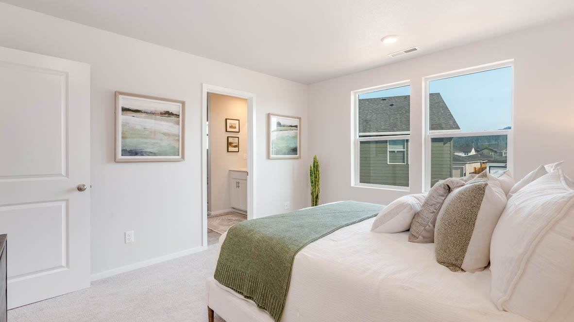 Marcola Meadows Primary bedroom with bed, windows, nightstand with lamp