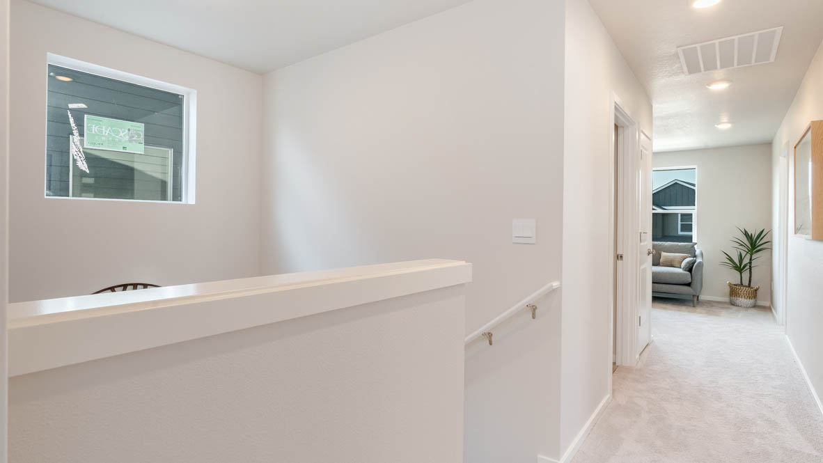Marcola Meadows hallway with carpet, window, and staircase