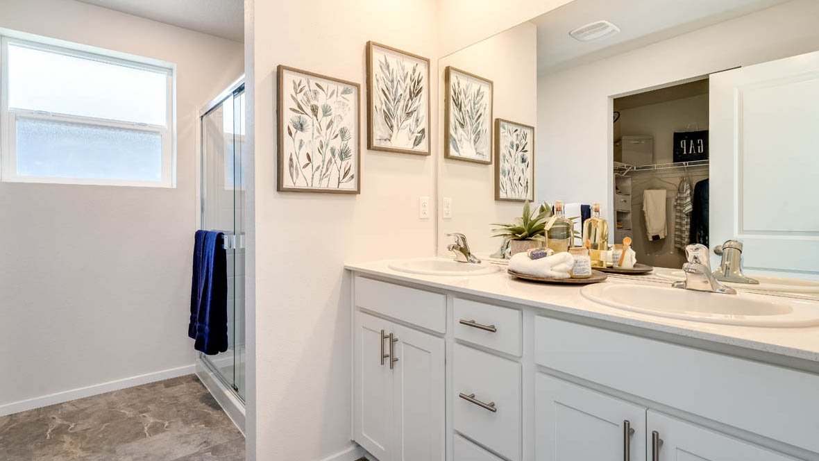 Marcola Meadows Bathroom that includes double sinks vanity with white cabinet and countertops right next to the standing shower