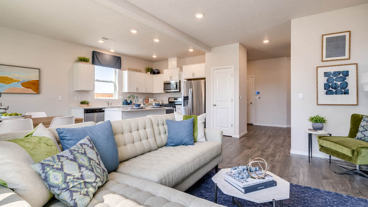 Marcola Meadows White couch in the great room and kitchen with white cabinets