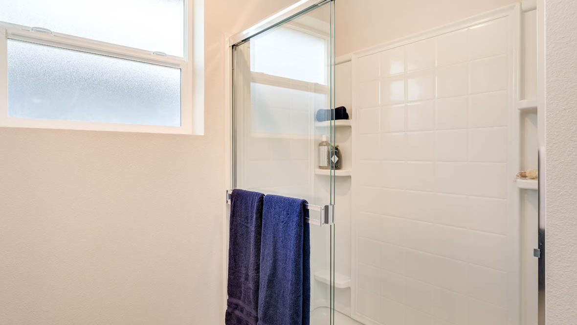 Marcola Meadows Bathroom walk in shower with stained glass window