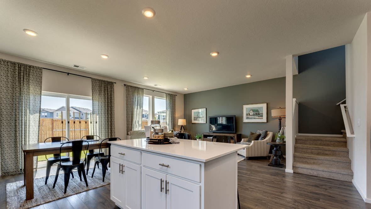 Marcola Meadows Kitchen with white cabinet, an island, stainless steel kitchen appliances, and dining room and patio door in the back