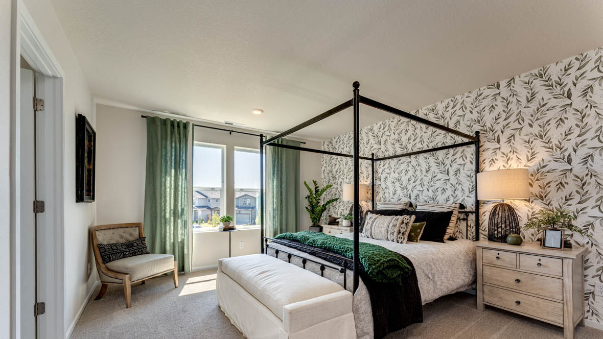 Marcola Meadows Bedroom with a king size bed and a green leafy accent wall and two windows