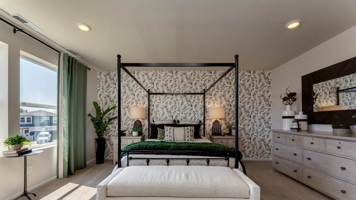 Marcola Meadows Bedroom with a king size bed and a green leafy accent wall and two windows